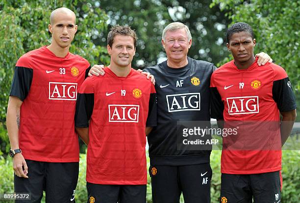Manchester United manager Sir Alex Ferguson poses with his new signings at the Club's Carrington training grounds in Manchester, on July 13, 2009....