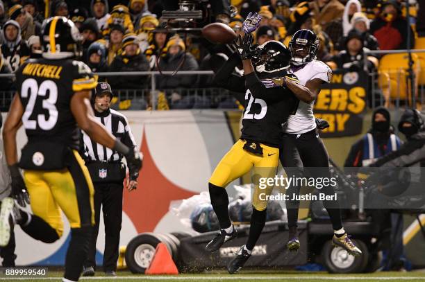 Artie Burns of the Pittsburgh Steelers breaks up a pass intended for Mike Wallace of the Baltimore Ravens in the third quarter during the game at...