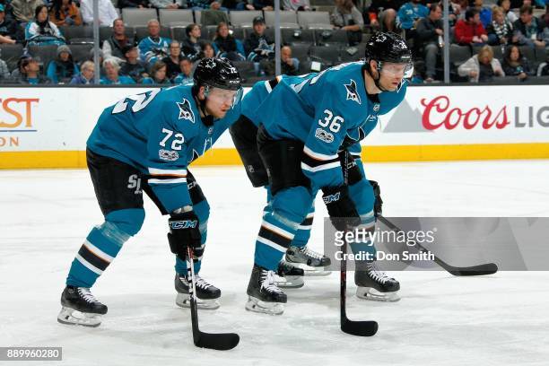 Tim Heed and Jannik Hansen of the San Jose Sharks get ready during a NHL game against the Minnesota Wild at SAP Center on December 10, 2017 in San...