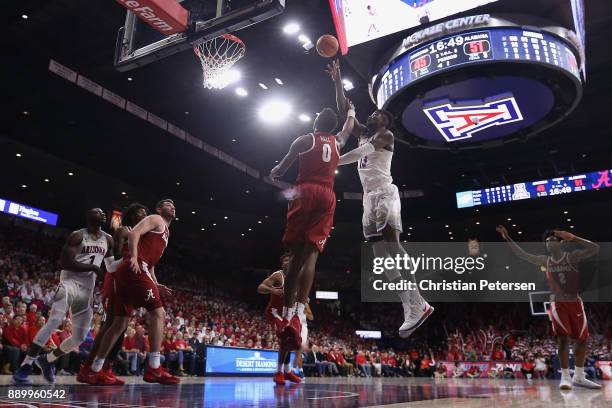 Deandre Ayton of the Arizona Wildcats puts up a shot over Donta Hall of the Alabama Crimson Tide during the second half of the college basketball...