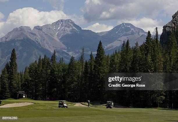 Golfers work their way along the wide, green fairways at the Fairmont Banff Springs golf course as seen in this 2009 Banff Springs, Canada, summer...