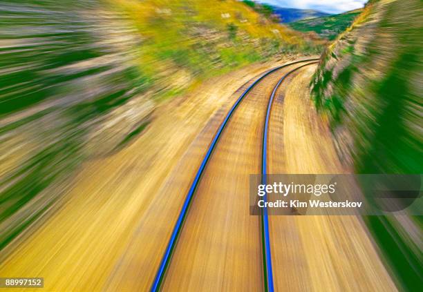 railway tracks curving right, blurred motion     - westerskov stock pictures, royalty-free photos & images