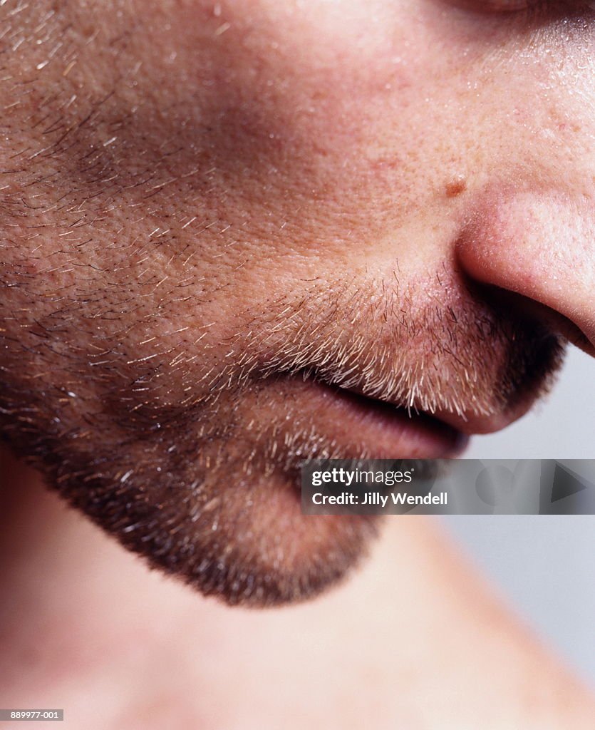 Young man unshaven face, close-up