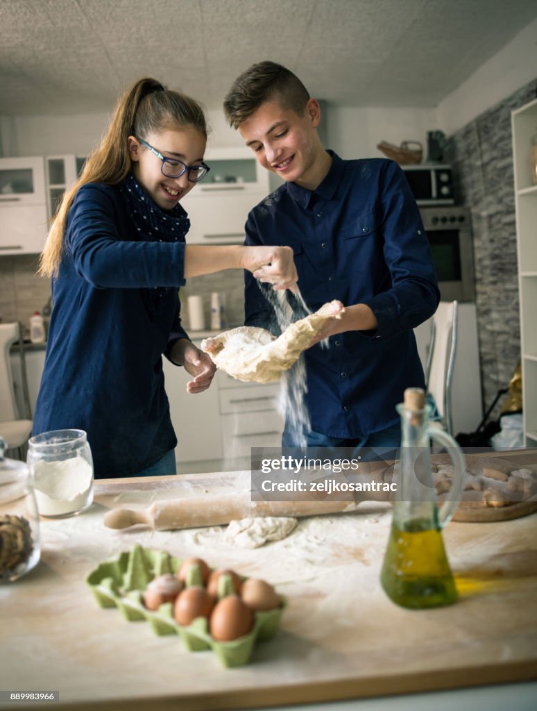 Family funny kids bake cookies in kitchen