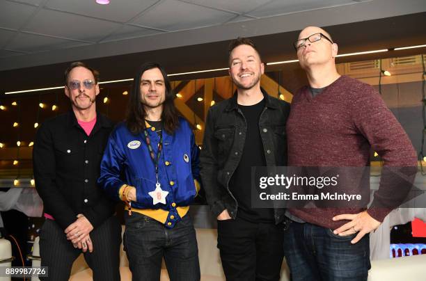 Ted Stryker with Scott Shriner, Brian Bell, and Patrick Wilson of Weezer pose backstage during KROQ Almost Acoustic Christmas 2017 at The Forum on...
