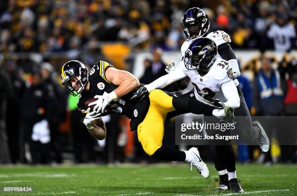 Jesse James of the Pittsburgh Steelers makes a catch in front of Eric Weddle of the Baltimore Ravens in the second half during the game at Heinz...