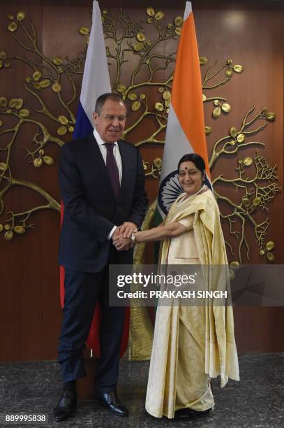 Indian External Affairs Minister Sushma Swaraj shakes hands with Russian Foreign Minister Sergey Lavrov ahead of a meeting in New Delhi on December...