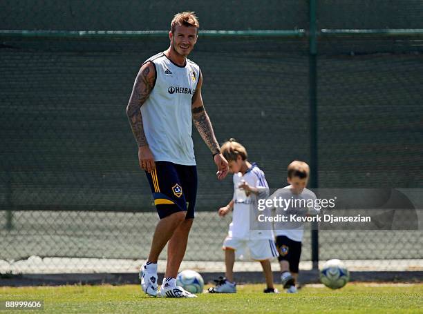 David Beckham, with his children Romeo Beckham , and Cruz Beckham looking on, practices with the Los Angeles Galaxy for the first time this year...