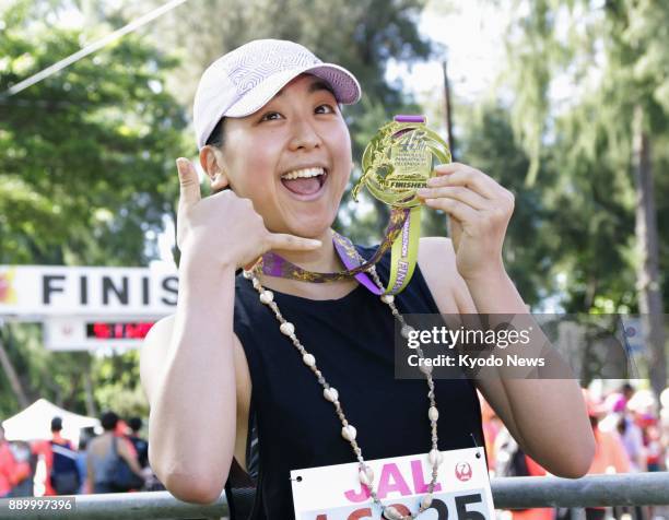 Retired Japanese figure skater Mao Asada poses after completing her first full-distance marathon in Honolulu on Dec. 10, 2017. The former world...