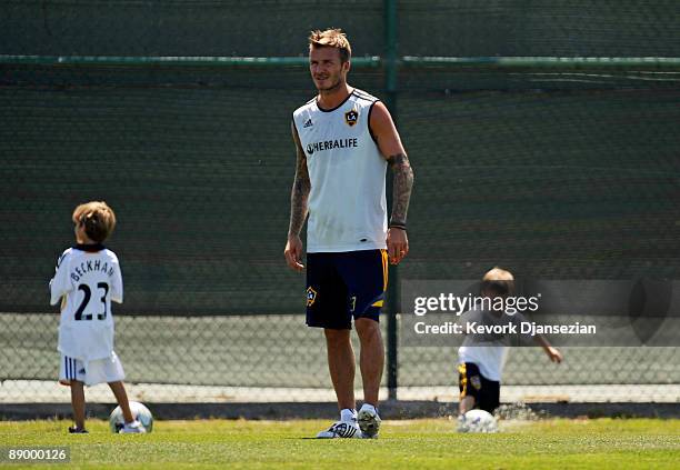 David Beckham, with his children Romeo Beckham , and Cruz Beckham looking on, practices with the Los Angeles Galaxy for the first time this year...