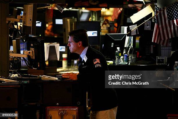 Trader works on the floor near the end of the trading day on the New York Stock Exchange on July 13, 2009 in New York City. A rise in bank stocks saw...
