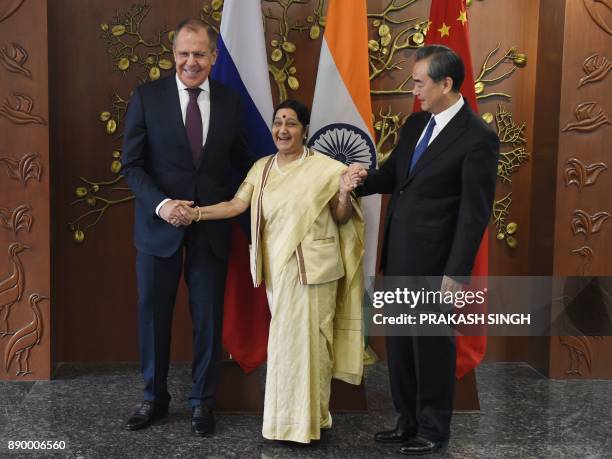 Russian Foreign Minister Sergey Lavrov , Indian External Affairs Minister Sushma Swaraj and Chinese Foreign Minister Wang Yi pose for a photograph...