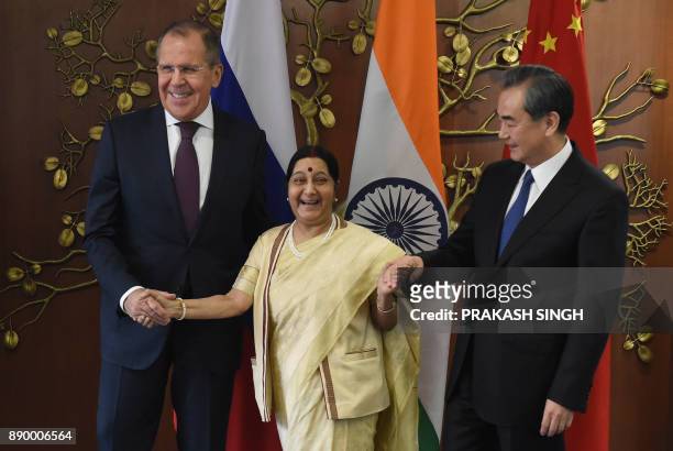 Russian Foreign Minister Sergey Lavrov , Indian External Affairs Minister Sushma Swaraj and Chinese Foreign Minister Wang Yi pose for a photograph...