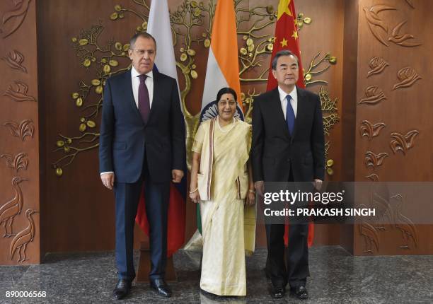 Russian Foreign Minister Sergey Lavrov , Indian External Affairs Minister Sushma Swaraj and Chinese Foreign Minister Wang Yi pose for a photograph...