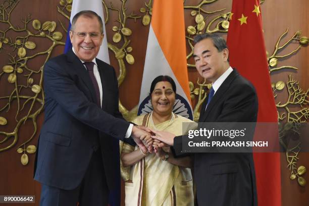 Russian Foreign Minister Sergey Lavrov , Indian External Affairs Minister Sushma Swaraj and Chinese Foreign Minister Wang Yi pose for a photograph...