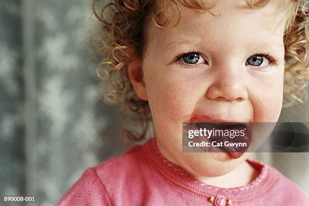 young girl (2-4) licking strawberry jam off lips, portrait - licking lips stock pictures, royalty-free photos & images