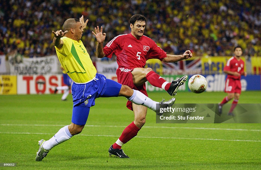 Ronaldo of Brazil and Alpay Ozalan of Turkey