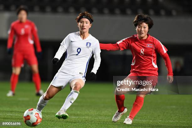 Kang Yumi of South Korea and Yu Jong Im of North Korea compete for the ball during the EAFF E-1 Women's Football Championship between North Korea and...