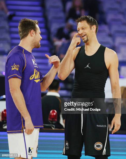 Brad Newley of the Kings catches up with David Anderson of United in the warm up during the round nine NBL match between Melbourne United and the...