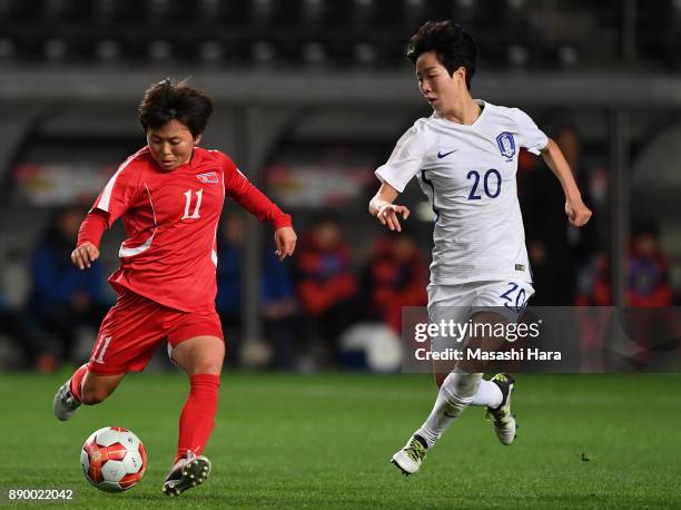 Sung Hyang Sim of North Korea and Kim Hyeri of South Korea compete for the ball during the EAFF E-1 Women's Football Championship between North Korea...