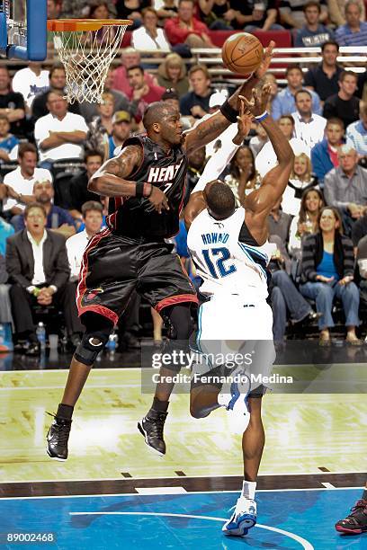 Jermaine O'Neal of the Miami Heat blocks the shot by Dwight Howard of the Orlando Magic during the game on February 22, 2009 at Amway Arena in...