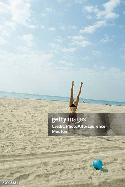 teen girl doing handstand on beach - handstand beach stock pictures, royalty-free photos & images