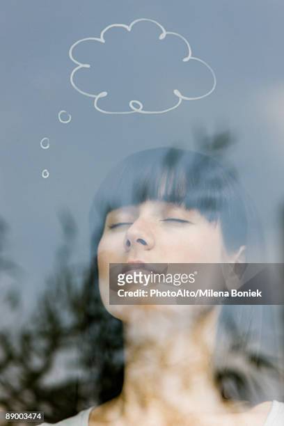 young woman with thought bubble over head - above clouds stock-fotos und bilder