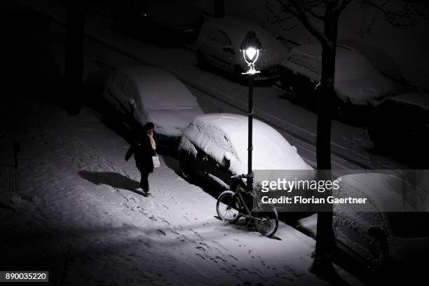 Woman walks along a snow-covered pavement on December 10, 2017 in Berlin, Germany.