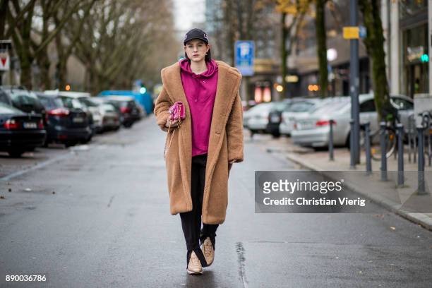 Maria Barteczko wearing a camel iconic teddy coat Max Mara, burgundy hoodie Asos, black slim ankle trousers H&M, metallic Air Max 97 Ultra 17 Niike,...