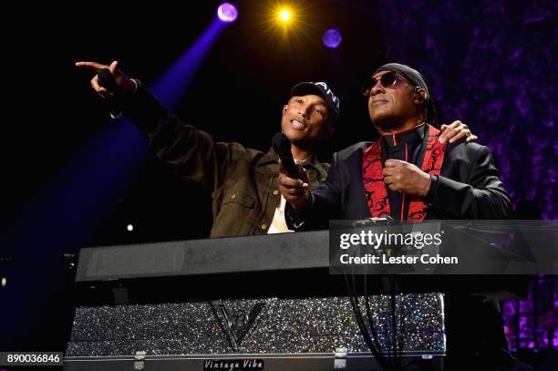 Pharrell Williams and Stevie Wonder perform onstage during Stevie's 21st Annual House Full of Toys Benefit Concert at Staples Center on December 10,...