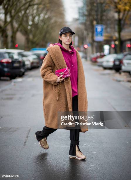 Maria Barteczko wearing a camel iconic teddy coat Max Mara, burgundy hoodie Asos, black slim ankle trousers H&M, metallic Air Max 97 Ultra 17 Niike,...