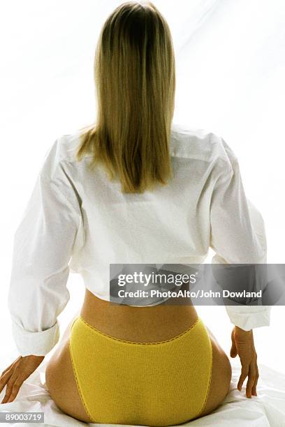 woman wearing underwear and button down shirt, rear view - bottom up ストックフォトと画像