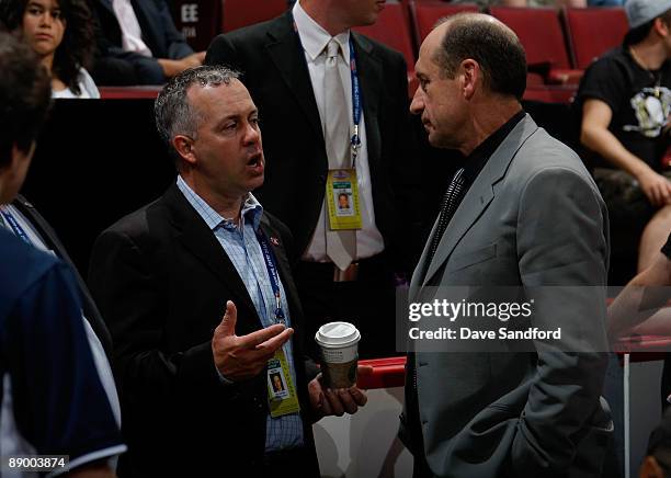 Ray Lalonde and General Manager Bob Gainey of the Montreal Canadiens share a conversation during the second day of the 2009 NHL Entry Draft at the...