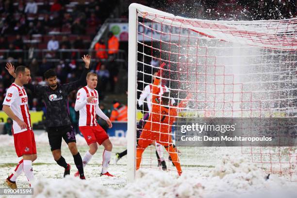 Snow falls of the goal net as Nils Petersen of SC Freiburg shoots and scores his side's first goal during the Bundesliga match between 1. FC Koeln...