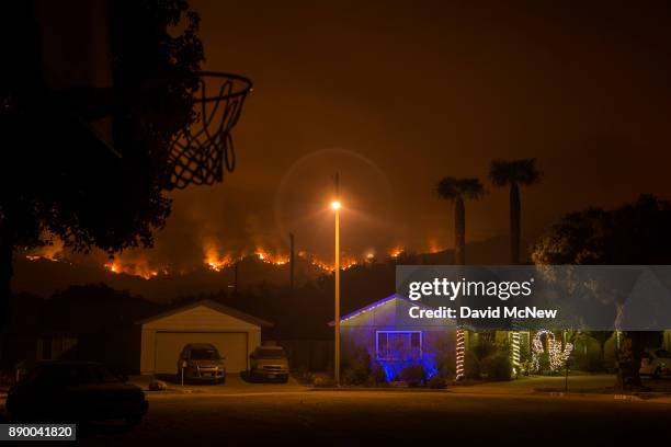 Christmas decorations illuminate a house as the growing Thomas Fire advances toward Santa Barbara County seaside communities on December 10, 2017 in...