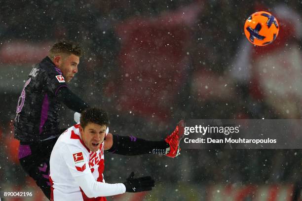 Yoric Ravet of SC Freiburg battles for the ball with Dominique Heintz of FC Koeln during the Bundesliga match between 1. FC Koeln and Sport-Club...