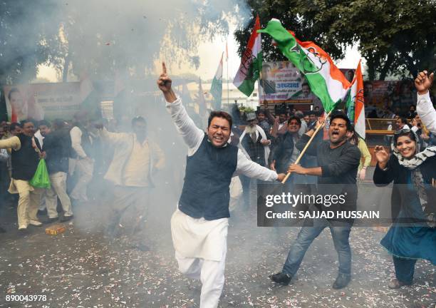 Indian supporters of the Congress Party shout slogans after the party named Rahul Gandhi president, outside Congress headquarters in New Delhi on...