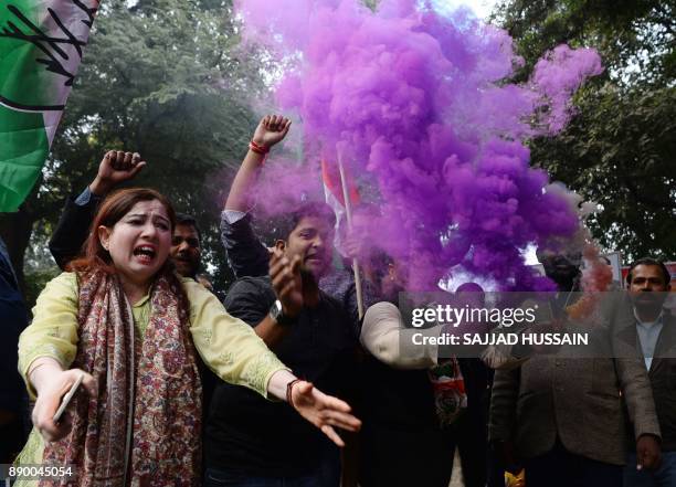 Indian supporters of the Congress Party shout slogans after the party named Rahul Gandhi president, outside Congress headquarters in New Delhi on...