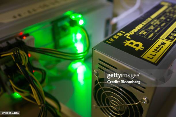 Bitcoin logo sits on a LL 1800W power unit supplying cryptocurrency mining machines at the SberBit mining 'hotel' in Moscow, Russia, on Saturday,...