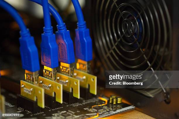 Data connector cables sit on a circuit board used in cryptocurrency mining machines at the SberBit mining 'hotel' in Moscow, Russia, on Saturday,...