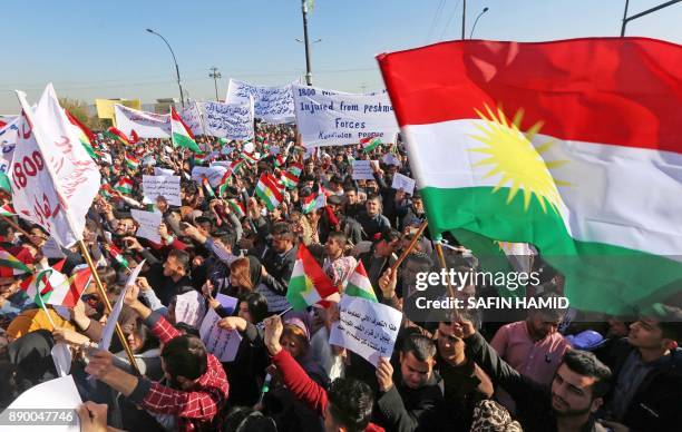 Iraqi Kurdish students of the Salahaddin University, wave the Kurdish flag as they demonstrate in Arbil, the capital of autonomous Iraqi Kurdistan...