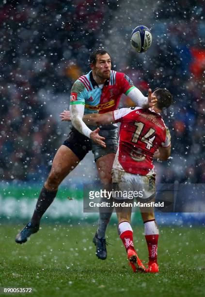 Tim Visser of Harlequins jumps for the ball as a tackle comes in from Craig Gilroy of Ulster during the European Rugby Champions Cup match between...