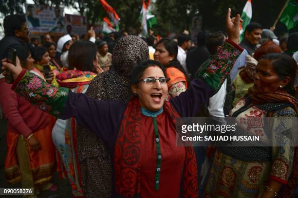 Indian supporters of the Congress Party dance after the party named Rahul Gandhi president, outside Congress headquarters in New Delhi on December...