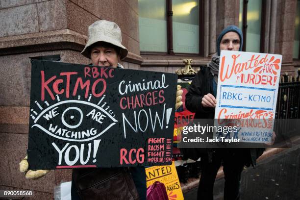 Protesters hold placards outside Holborn Bars before a two-day hearing as part of the inquiry into the Grenfell Tower fire on December 11, 2017 in...