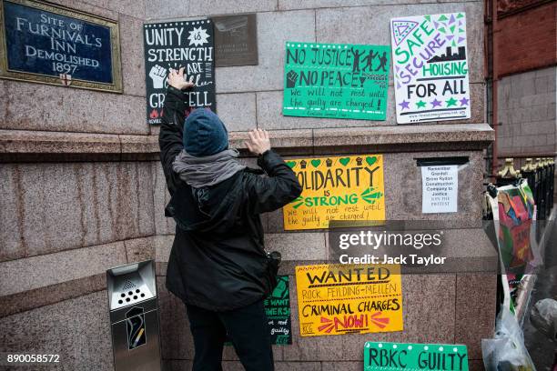 Protesters gather with placards outside Holborn Bars before a two-day hearing as part of the inquiry into the Grenfell Tower fire on December 11,...