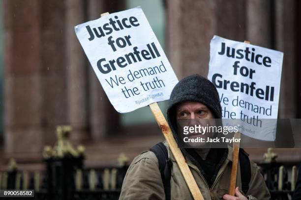 Protesters gather with placards outside Holborn Bars before a two-day hearing as part of the inquiry into the Grenfell Tower fire on December 11,...