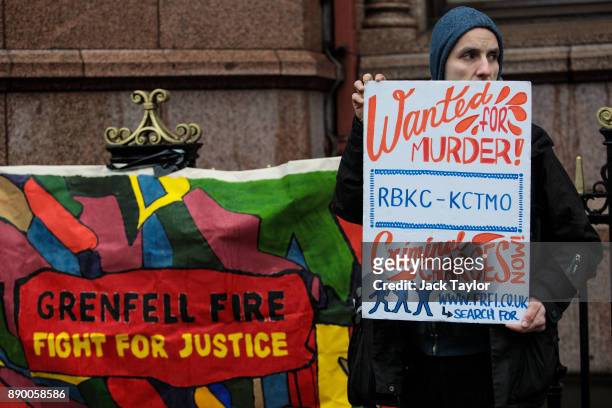 Protesters gather with placards outside Holborn Bars before a two-day hearing as part of the inquiry into the Grenfell Tower fire on December 11,...