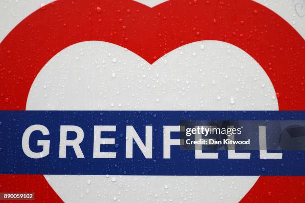 Rain drips down a Grenfell sign at the foot of the tower on December 11, 2017 in London, England. An inquiry into the Grenfell Tower fire was is due...