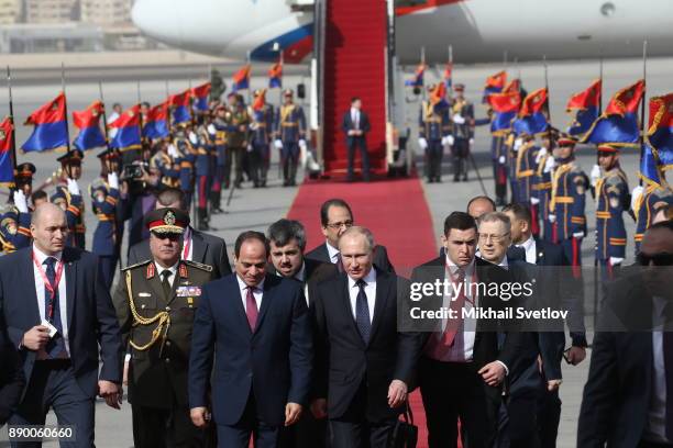 Russian President Vladimir Putin and Egyptian President Abdel Fattah el-Sisi attend a welcoming ceremony at the airport on December 11, 2017 in...