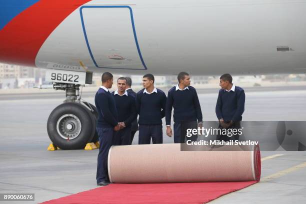 Egyptian airport workers await for Russian President Vladimir Putin's arrival proir the welcoming ceremony at the airport on December 11, 2017 in...